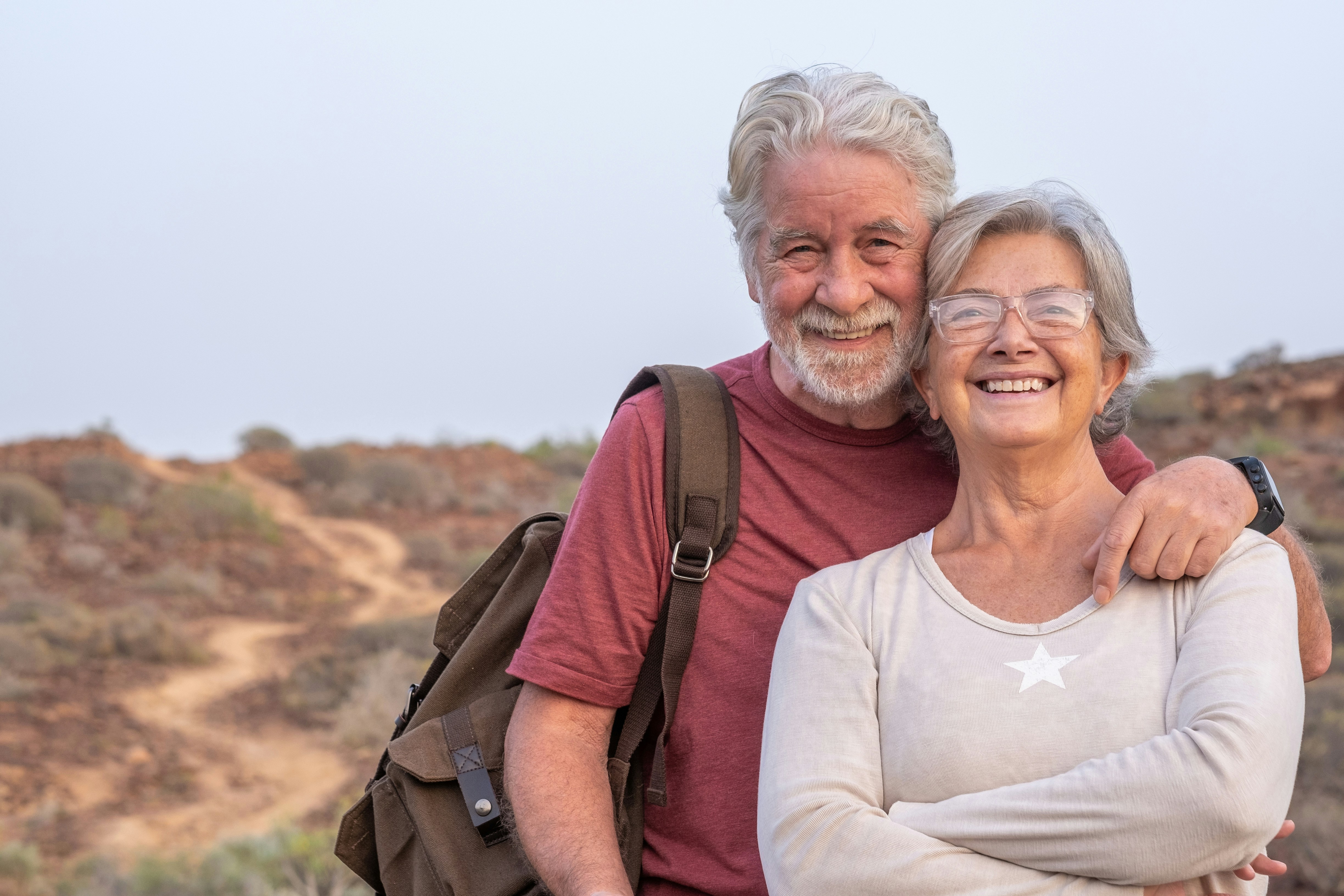Smiling retired couple enjoying time together, representing peace of mind and support with Medicare coverage